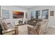 Comfortable living room featuring reclining sofa seating, modern decor, and natural light from large windows at 14925 Lebeau Loop, Winter Garden, FL 34787