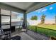 Relaxing screened patio with brick flooring overlooking a spacious backyard and a white fence at 14925 Lebeau Loop, Winter Garden, FL 34787