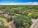 Aerial view showcases the community's landscape, mature trees, and proximity to roads at 1591 Revere Ln, Daytona Beach, FL 32117