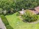 Aerial view of a well-maintained home with lush landscaping and a neatly manicured lawn at 1591 Revere Ln, Daytona Beach, FL 32117