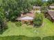 Home aerial view with lush landscaping and a neatly manicured lawn at 1591 Revere Ln, Daytona Beach, FL 32117