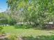 Secluded backyard space with lush greenery and mature trees, creates a serene outdoor setting at 1591 Revere Ln, Daytona Beach, FL 32117