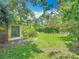 Spacious backyard with manicured lawn and mature landscaping, offering privacy and shade at 1591 Revere Ln, Daytona Beach, FL 32117