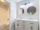 Bright bathroom with a dual sink vanity and modern lighting at 1591 Revere Ln, Daytona Beach, FL 32117