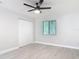 Bedroom featuring new hardwood floors, ceiling fan and closet at 1591 Revere Ln, Daytona Beach, FL 32117