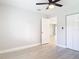 The bright bedroom features neutral walls, wood-look flooring, a closet, and a ceiling fan at 1591 Revere Ln, Daytona Beach, FL 32117