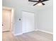 This bedroom has a closet, ceiling fan, neutral walls, wood-look flooring, and baseboards at 1591 Revere Ln, Daytona Beach, FL 32117