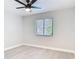 Cozy bedroom features a ceiling fan, neutral paint, window with blinds, and wood-look flooring at 1591 Revere Ln, Daytona Beach, FL 32117