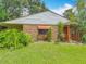 A charming home with brick and siding, complemented by lush landscaping and a welcoming entrance at 1591 Revere Ln, Daytona Beach, FL 32117