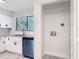 Renovated kitchen featuring modern appliances, granite countertops, and a convenient laundry closet at 1591 Revere Ln, Daytona Beach, FL 32117