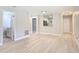 Open-concept living room with views to the kitchen, neutral walls, and wood-look flooring at 1591 Revere Ln, Daytona Beach, FL 32117