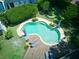 Aerial view showcasing a private backyard with a uniquely shaped pool and a spacious deck with lounge seating at 1791 Spruce Ave, Winter Park, FL 32789