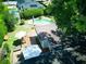 Aerial shot displaying a backyard with a unique pool, wooden deck with patio furniture, and verdant hedges at 1791 Spruce Ave, Winter Park, FL 32789