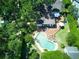 Overhead view of a secluded backyard featuring a freeform pool, sunbathing deck, and manicured greenery at 1791 Spruce Ave, Winter Park, FL 32789