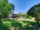 Lush backyard with inviting pool, lounge chairs, umbrella and hammock great for relaxation and entertainment at 1791 Spruce Ave, Winter Park, FL 32789