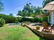 Lush backyard oasis featuring a pristine pool area, deck with outdoor seating, and mature landscaping for ultimate relaxation at 1791 Spruce Ave, Winter Park, FL 32789