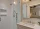 Modern bathroom featuring a glass-enclosed shower with white subway tile and a vanity with marble countertop at 1791 Spruce Ave, Winter Park, FL 32789