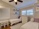 Bright bedroom with twin beds, white furniture, shuttered windows, ceiling fan, and hardwood floors at 1791 Spruce Ave, Winter Park, FL 32789