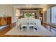 Dining room with chandelier, hardwood floors, decorative cabinet and doorway to the living room at 1791 Spruce Ave, Winter Park, FL 32789