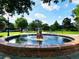 Picturesque water fountain with a brick base in a landscaped park setting on a sunny day at 1791 Spruce Ave, Winter Park, FL 32789