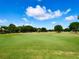 Sprawling green golf course under a blue sky with scattered clouds, perfect for a relaxing day of golf at 1791 Spruce Ave, Winter Park, FL 32789