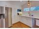 Well-lit kitchen features white cabinets, stainless steel appliances, and ample counter space at 1791 Spruce Ave, Winter Park, FL 32789