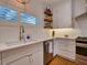 Modern kitchen featuring white cabinets, stainless steel appliances, and ample natural light at 1791 Spruce Ave, Winter Park, FL 32789