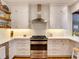 Bright, updated kitchen features white cabinets, subway tile backsplash, and stainless steel appliances at 1791 Spruce Ave, Winter Park, FL 32789