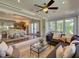 Cozy living room with large sectional sofa, glass-top coffee table, and dining room view at 1791 Spruce Ave, Winter Park, FL 32789