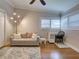 Inviting living room featuring a comfortable sofa, bright windows, hardwood floors, and stylish decor at 1791 Spruce Ave, Winter Park, FL 32789