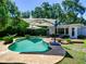 Backyard with an inviting pool, lounge seating, wood deck and lush landscaping, creating a perfect outdoor retreat at 1791 Spruce Ave, Winter Park, FL 32789