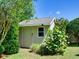 A quaint storage shed is nestled among verdant greenery, providing practical space and blending into the landscape at 1791 Spruce Ave, Winter Park, FL 32789