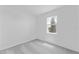 Bright bedroom with a large window, neutral carpet, and fresh white walls at 2026 Firethorn Loop, Haines City, FL 33844