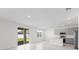 Bright, open-concept kitchen and living space with sliding glass doors and contemporary finishes at 2026 Firethorn Loop, Haines City, FL 33844