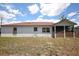 Home exterior with a screened-in patio and lawn at 2041 Swanson Dr, Deltona, FL 32738