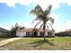 Charming single-story home with well-maintained lawn and a mature palm tree in a sunny neighborhood at 2041 Swanson Dr, Deltona, FL 32738