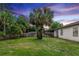 Spacious backyard featuring a privacy fence, mature trees, and lush lawn at 20723 Macon Pkwy, Orlando, FL 32833