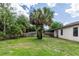 Spacious backyard featuring a privacy fence, mature trees, and lush lawn at 20723 Macon Pkwy, Orlando, FL 32833