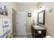 Neutral bathroom featuring granite vanity, framed mirror, and decorative art at 20723 Macon Pkwy, Orlando, FL 32833