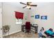 This bedroom features neutral walls, plush carpet, ceiling fan, and a window with a red curtain at 20723 Macon Pkwy, Orlando, FL 32833