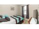 Cozy bedroom features stylish bedding, dark curtains, neutral walls, and a TV at 20723 Macon Pkwy, Orlando, FL 32833