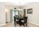 Cozy dining room featuring a modern chandelier, table set for four, and sliding glass doors at 20723 Macon Pkwy, Orlando, FL 32833