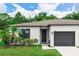 Charming single-story home with a well-manicured lawn, lush landscaping, and a convenient one-car garage at 20723 Macon Pkwy, Orlando, FL 32833