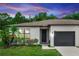 Charming single-story home with a well-manicured lawn, lush landscaping, and a convenient one-car garage at 20723 Macon Pkwy, Orlando, FL 32833