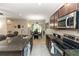 Modern kitchen featuring granite countertops, stainless steel appliances, and an adjacent dining area at 20723 Macon Pkwy, Orlando, FL 32833