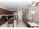 Open-concept kitchen with stainless steel appliances, granite counters, and a view into the living area at 20723 Macon Pkwy, Orlando, FL 32833