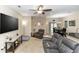 Comfortable living room with ample seating, a ceiling fan, and seamless access to the dining area at 20723 Macon Pkwy, Orlando, FL 32833