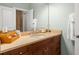Bright bathroom featuring a single sink vanity with tan marble countertops at 2223 Amherst Ave, Orlando, FL 32804
