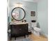 Stylish powder room with a vanity, round mirror, and a toilet, all in a well-lit space at 2223 Amherst Ave, Orlando, FL 32804