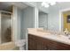 Bright bathroom with a walk-in shower, vanity with a granite counter, and a large mirror at 2223 Amherst Ave, Orlando, FL 32804